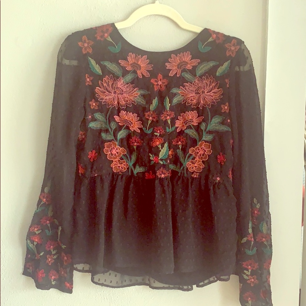 Long sleeved black blouse with colorful detailing